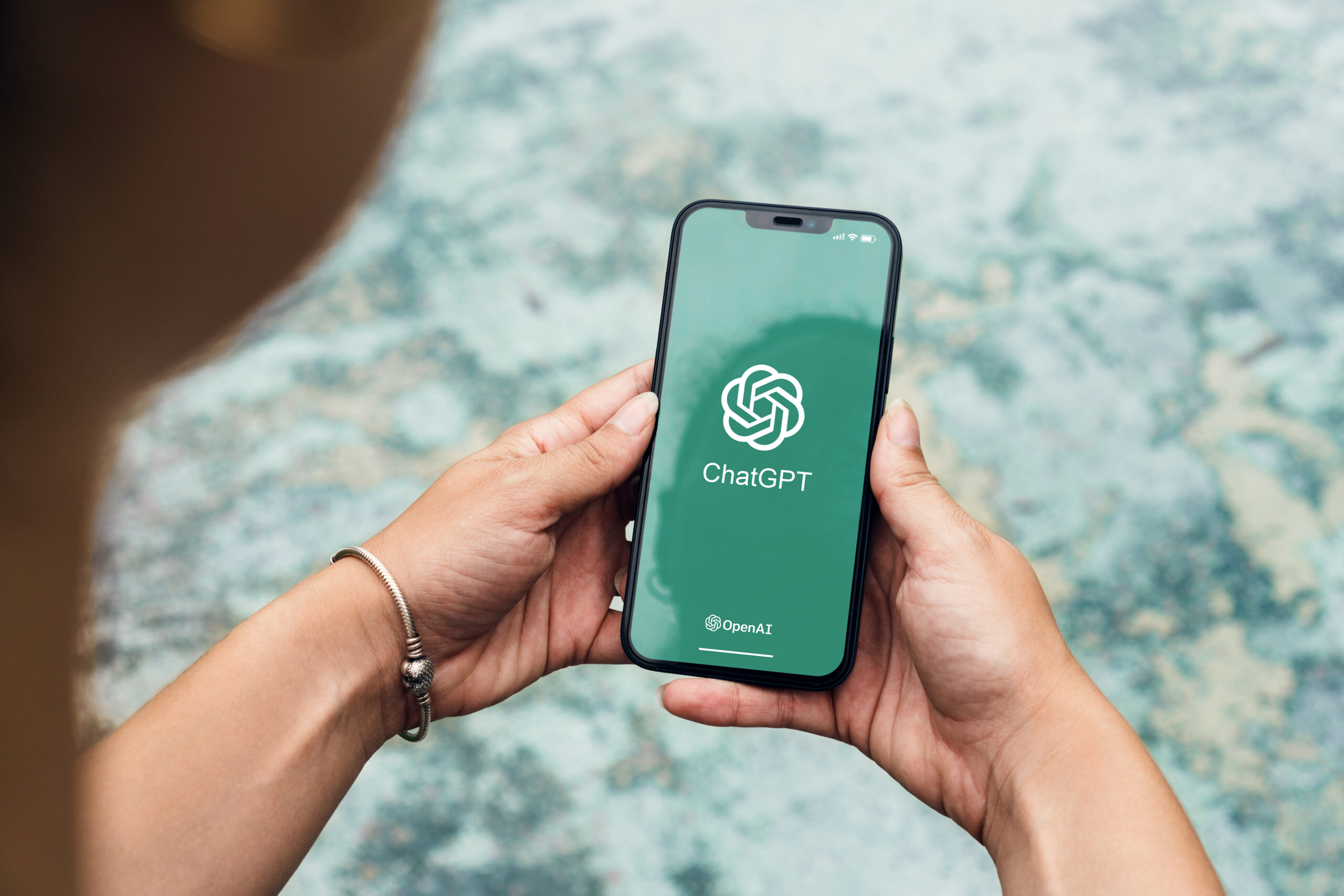 girl in the park holding a smartphone with chatgpt artificial in